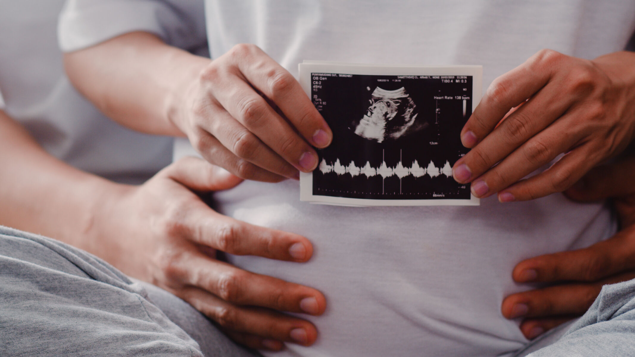 young-asian-pregnant-couple-show-looking-ultrasound-photo-baby-belly-mom-dad-feeling-happy-smiling-peaceful-while-take-care-child-lying-sofa-living-room-home.jpg